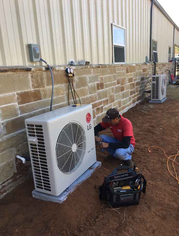 Technician tinkering an AC unit Aledo, TX